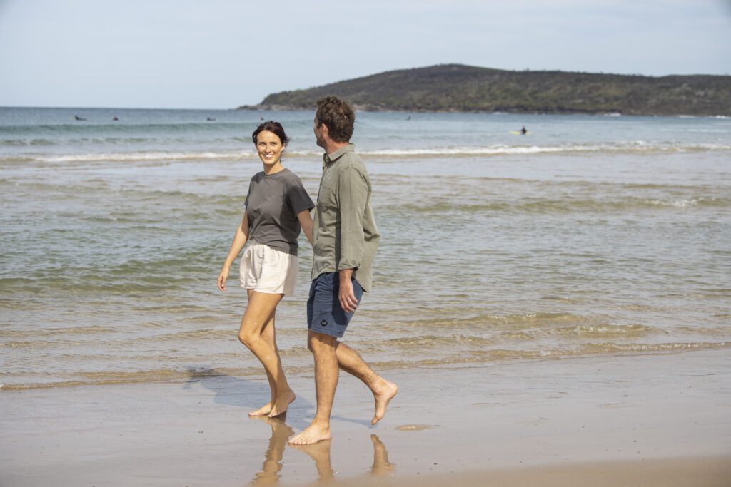 Couple enjoying a walk along the Yuraygir Coastal Walk, Angourie.