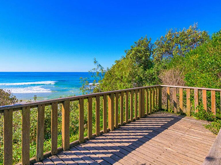The view of the beach from a deck at Illaroo campground in Yuraygir National Park. Photo: Jessica