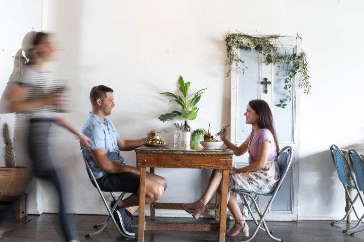 Couple enjoying food and drinks at Heart and Soul Wholefood Cafe, Grafton.